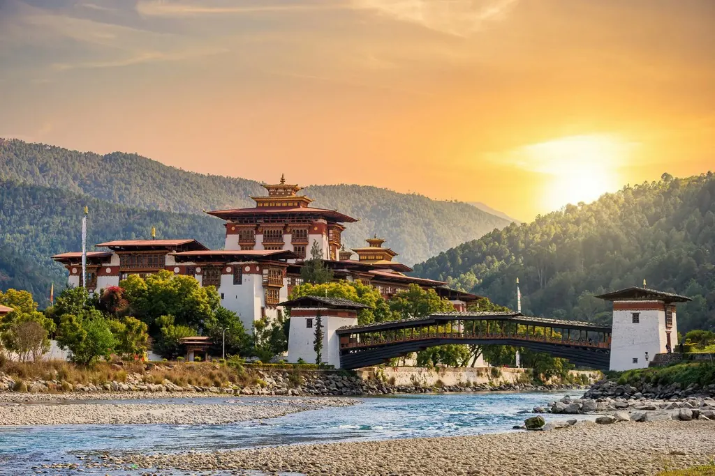 A dzong by the river at sunrise, Bhutan